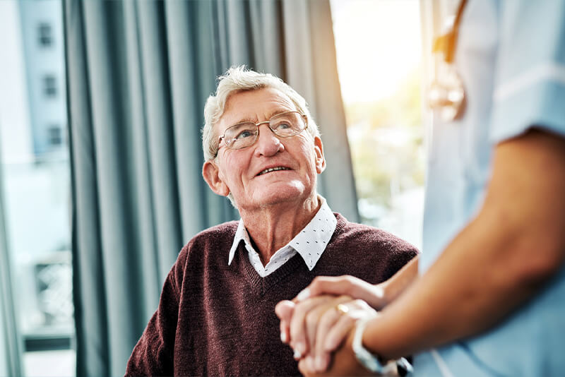 holding older gentleman's hand