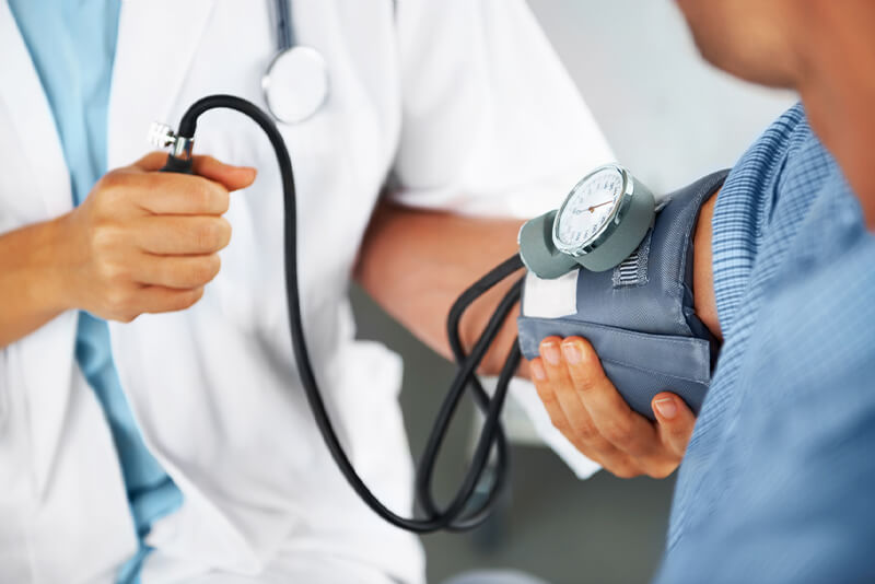 doctor measuring patient's blood pressure