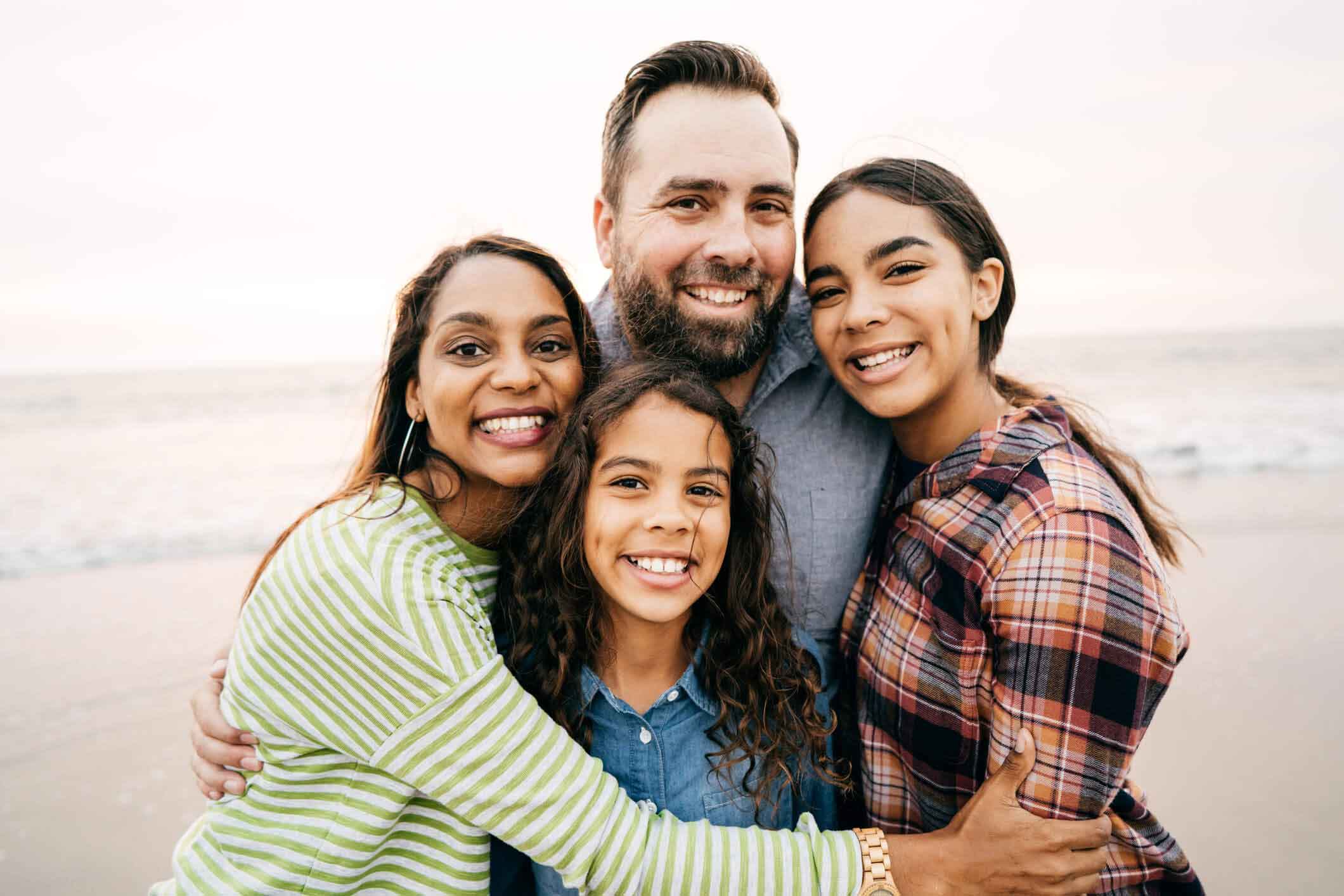 family of four smiling